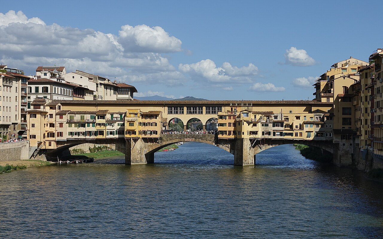 Ponte Vecchio’s buildings and arches reflected in the Arno in Florence