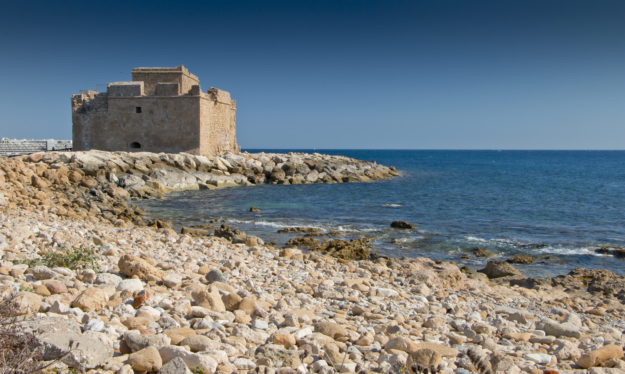 Paphos harbour fort beside the Mediterranean and a rocky shoreline